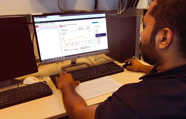 A Facilio user oversees enterprise-wide facilities performance at his desk.