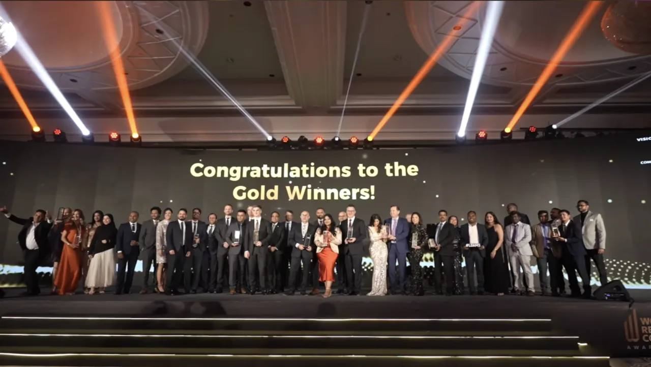 Berkeley and Facilio team on stage receiving a gold award